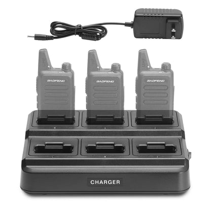 Four Baofeng walkie talkies on a charging station with a power adapter.