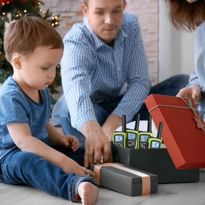 Child and adult interacting with FS-T8 on a floor near a Christmas tree.