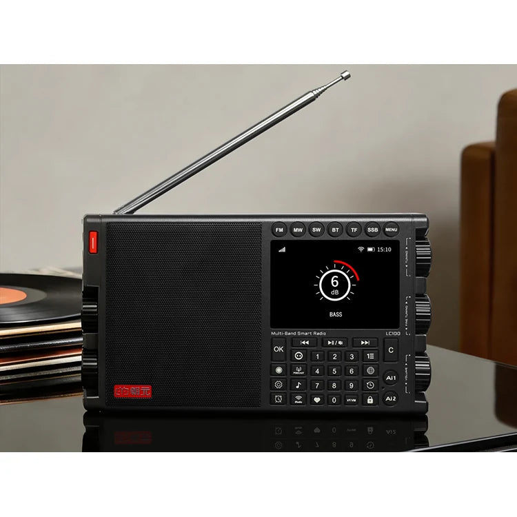 Black CHOYONG LC100 on a cabinet beside a record player with its Internet audio interface displayed